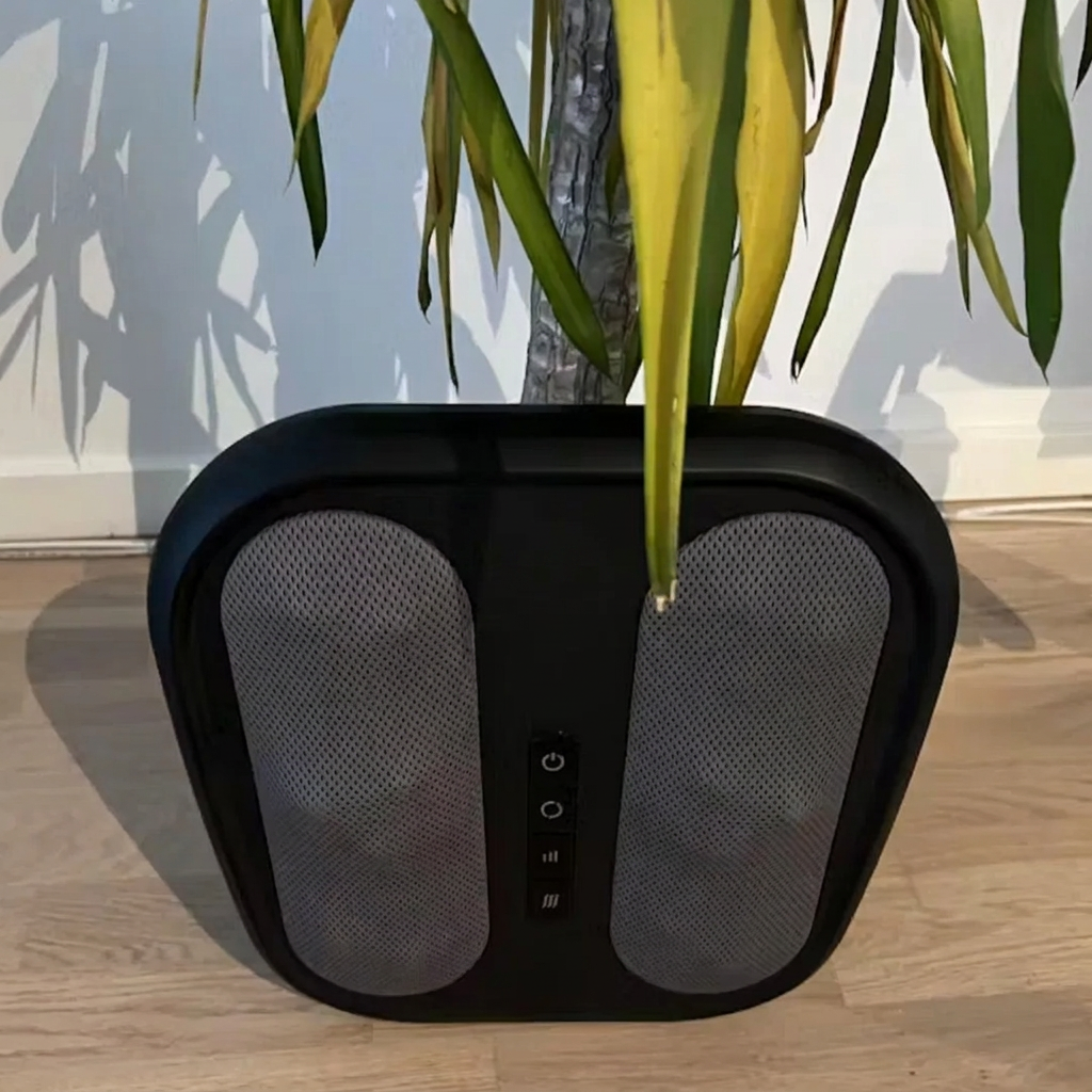 Fodlux Pro on the floor next to a plant